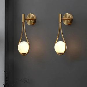 Vegglampe med frostet glasskule og dråpeformet metallramme